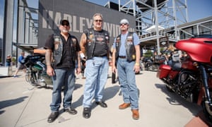 Six-String, Beer Man and Ferris stand in front of the Harley-Davidson Museum.