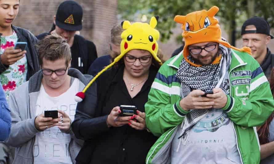 pokemon fans in hats playing pokemon go