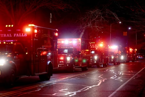 Ambulances line up along the street at night