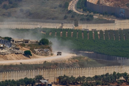 An Israeli military vehicle travelling past destroyed buildings in southern Lebanon on Sunday.