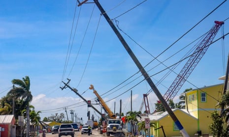 Vehicles navigate the damage as access to Matlacha, Florida, is reduced to a one-lane bridge