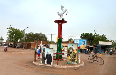 a roundabout with a poster showing two men shaking hands