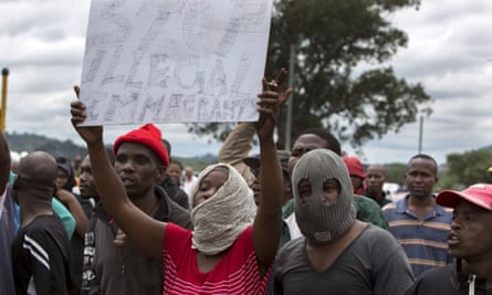South Africans wave anti-immigration placards during a protest in Pretoria.