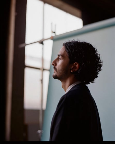 Side view of Imran Perretta with a white blind behind him