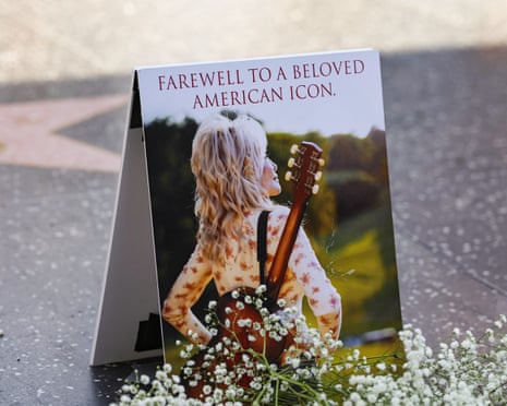 A portrait of Dolly Parton is placed among tributes near her Hollywood Walk of Fame star following her death.