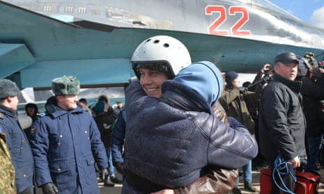 A Russian air force pilot is reunited with his family in the Voronezh region as the first group of Sukhoi Su-34 fighter bombers return from Syria on 15 March 2016. Photograph: Tass/Barcroft Media