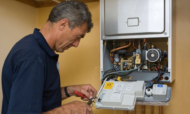 man working on a residential gas boiler.