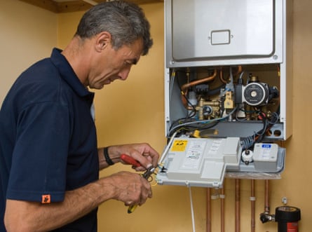 A man working on a gas boiler.