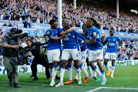 Everton’s players celebrate a goal by Abdoulayé Doucoure which earned them victory over Bournemouth at Goodison Park and ensured their survival in the Premier League.