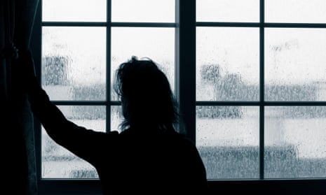 Woman looking out of window on rainy day