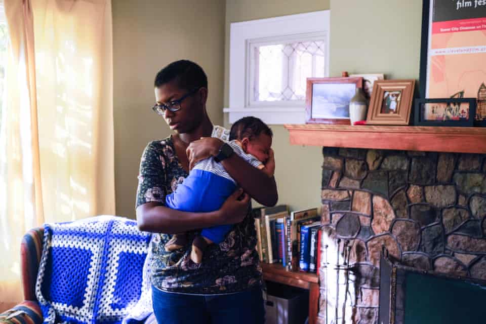 Rachel, 34, holds her son at home in Cleveland Heights, Ohio.