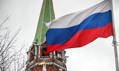 A Russian flag waves next to one of the Kremlin towers in Moscow