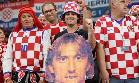 A Croatia fans holds a cardboard cutout of Luka Modric.