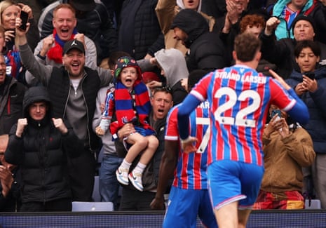 Crystal Palace fans celebrate after Ismaila Sarr scores their first goal.