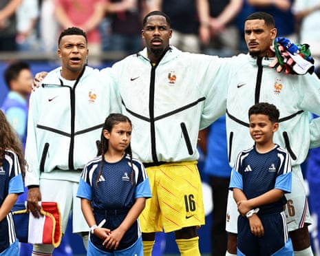 France's Kylian Mbappe, Mike Maignan and Maxence Lacroix during the national anthems.