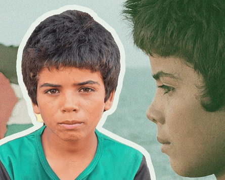 A young boy wearing a green T-shirt.