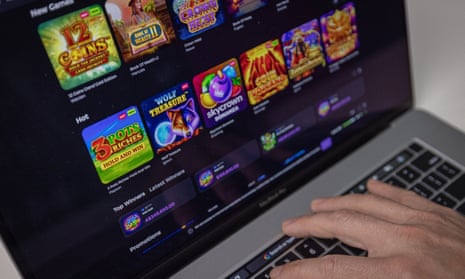 Person on laptop using online gambling slot machines