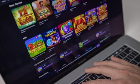 Person looking at various online casino slots games on a laptop