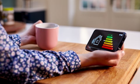 Woman holding smart energy meter measuring energy efficiency