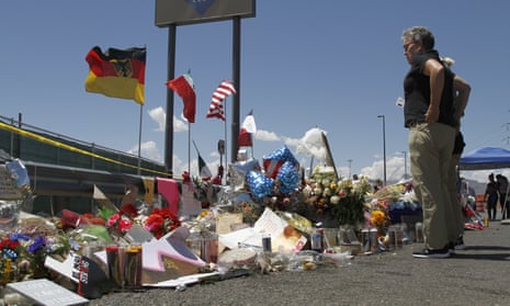 Mourners visit the makeshift memorial near the Walmart in El Paso, Texas, where 22 people were killed in a mass shooting.