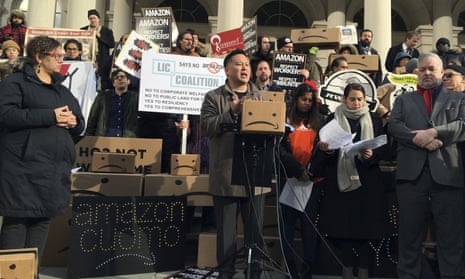 New York assemblyman Ron Kim, center, speaks at a rally opposing New York’s deal with Amazon on the steps of city hall on 12 December. 