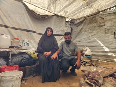 Ibtisam Saleh and her adult son inside the tent where they live