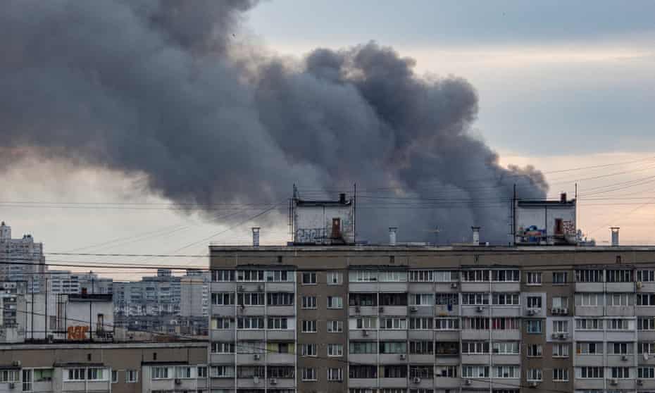 Smoke rises from above apartment buildings after Russia launched airstrikes on Kyiv.
