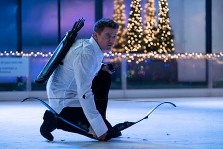 Renner in TV miniseries Hawkeye, 2021. He is carrying a bow and arrow and kneeling down on an ice rink.
