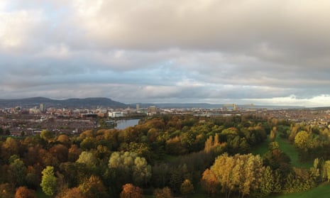 The canopy fringing the River Lagan seen from south Belfast, with the city and Cavehill in the background.