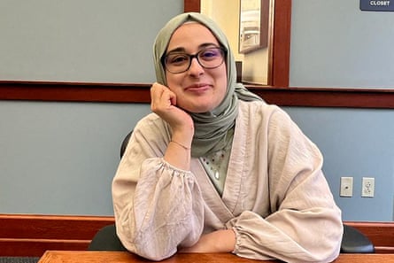 a woman with glasses smiling