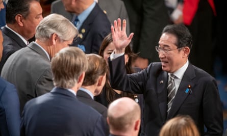 Fumio Kishida waving goodbye to members of congress following his speech on 11 April