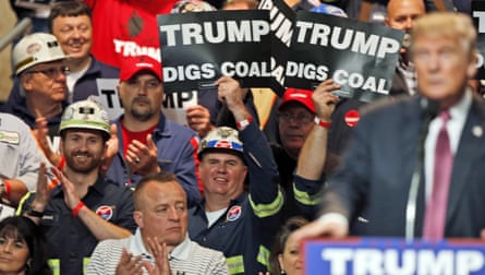 Coal miners wave signs reading ‘Trump digs coal’ as Donald Trump speaks during a rally in West Virginia on 5 May 2016.