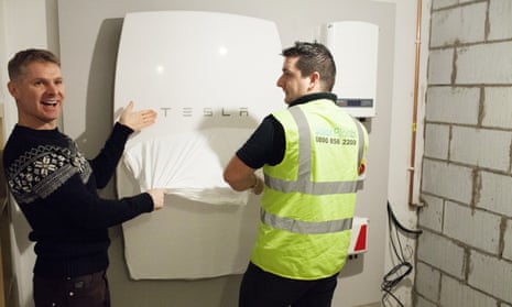 A SolarPlant engineer installs the UK’s first Powerwall home battery in Cardiff at Mark Keer and Lyndsey Bennett’s home