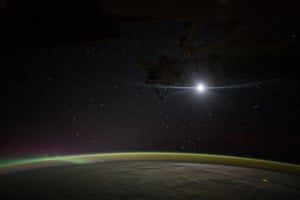 The moon rises over Earth
