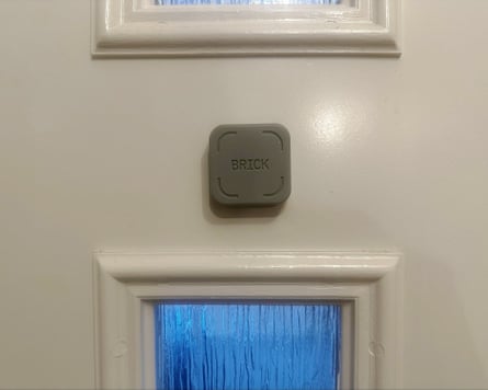 A Brick cube stuck to a door