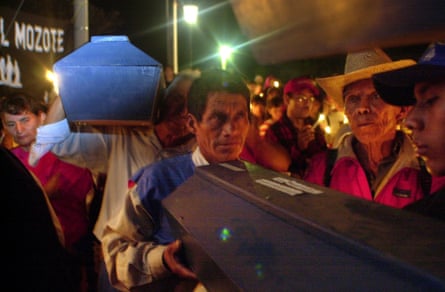 Relatives carry coffins containing the remains of victims in El Mozote in 2000, 19 years after the massacre.