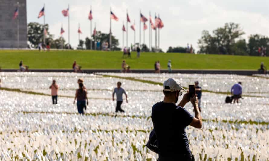 A visitor takes video with his phone at a tribute to the Americans who have died of Covid-19, on the National Mall in Washington in September 2021.