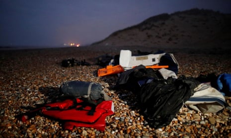 A damaged inflatable dinghy and a sleeping bag abandoned by migrants on the beach near Wimereux, France.