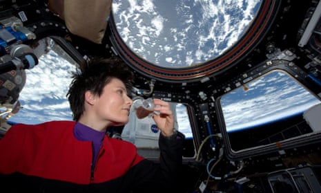 Italian astronaut Samantha Cristoforetti sips espresso from a cup designed for use in zero-gravity, on the International Space Station