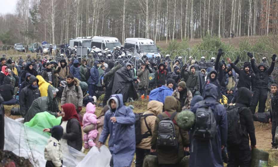 People from the Middle East and elsewhere gather at the Belarus-Poland border near Grodno, Belarus, on Monday