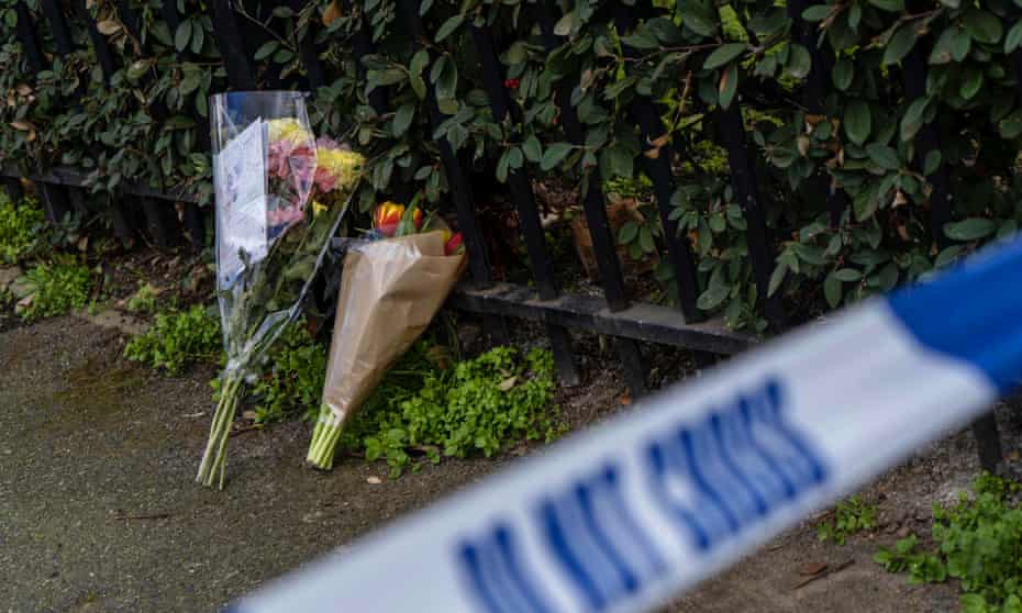 Bouquets of flowers lie at the scene of the fatal stabbing