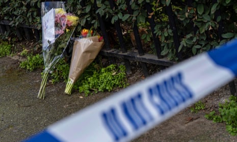 Bouquets of flowers lie at the scene of a fatal stabbing in London