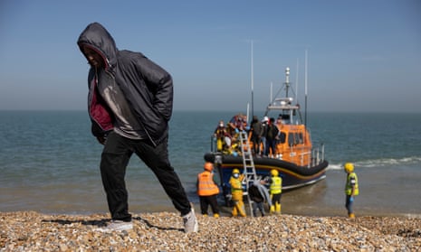 A group of migrants arrive via the RNLI (Royal National Lifeboat Institution) on Dungeness beach on September 7, 2021 in Dungeness, England
