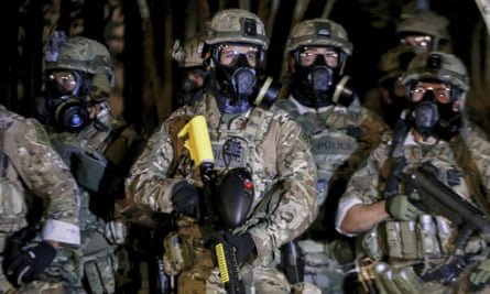 Police stand as protesters gather during a demonstration in Portland, Oregon.