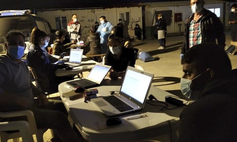 An image provided by the Greek coastguard shows passengers from the Turkish-flagged vessel being registered at a migration camp on the island of Kos