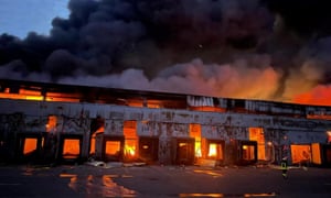 A warehouse storing frozen products on fire after shelling by Russian forces near Kyiv, Ukraine, on Saturday.
