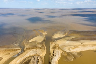A small river feeds into Bohai Bay at the Beikedi DiaoYu wetland park in Shandong province