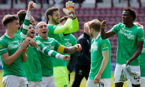 Celtic’s players celebrate clinching the title after the victory over Hearts.