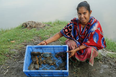 Sathi Das shows crabs from her afternoon catch.