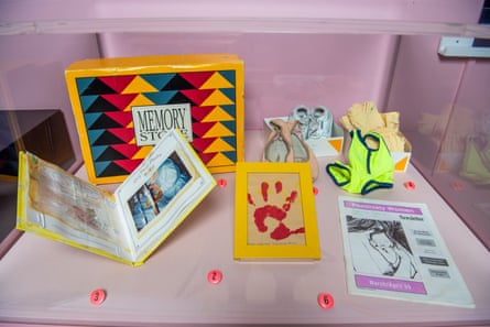 A card with a photo of a baby after delivery, a hand print, ballerina shoes and a newsletter